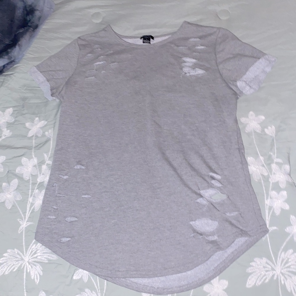 Grey shirt with rips for fashion. Women’s large. Great condition. Super cute.